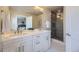 Bright bathroom showcasing dual sinks, a large mirror, and a glass-enclosed shower with tiled walls at 3378 W 17Th Ave, Denver, CO 80204