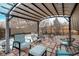 Relaxing patio area with pergola cover, perfect for outdoor entertaining at 2652 S Sable Way, Aurora, CO 80014