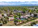 Aerial view showcasing a residential neighborhood with mature trees, homes, and distant mountain views at 3145 W Farmdale Rd, Englewood, CO 80110