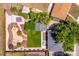 A birds eye view of fenced backyards with stone, green grass, a pool and a large tree at 3145 W Farmdale Rd, Englewood, CO 80110