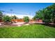 Spacious backyard with lush lawn, mature trees, and a charming seating area, ideal for outdoor enjoyment at 3145 W Farmdale Rd, Englewood, CO 80110