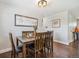 Cozy dining room with wood table, decorative lighting, neutral walls, and laminate wood flooring at 3145 W Farmdale Rd, Englewood, CO 80110