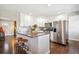 Modern kitchen featuring granite countertops, stainless steel appliances, white cabinets and wood flooring at 3145 W Farmdale Rd, Englewood, CO 80110