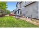 Serene backyard featuring a green lawn, patio area with seating, and privacy fencing at 12125 Helena St, Brighton, CO 80603