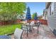 Serene backyard featuring a green lawn, patio area with seating, and privacy fencing at 12125 Helena St, Brighton, CO 80603