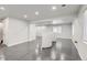 Open basement area with gray concrete floors and unique architectural features offers a modern aesthetic at 12125 Helena St, Brighton, CO 80603