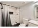 Stylish bathroom featuring a tiled shower with black fixtures, contrasting with the white tile and light walls at 12125 Helena St, Brighton, CO 80603