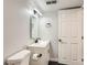 Modern bathroom with dark floors, a new vanity, new fixtures, and a door to the left at 12125 Helena St, Brighton, CO 80603