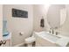 Bathroom with a sleek vanity, stylish faucet, and decorative mirror at 12125 Helena St, Brighton, CO 80603
