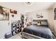 A casual bedroom featuring a bed, posters on the wall, a closet and shoe rack is neat and airy at 12125 Helena St, Brighton, CO 80603