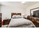 A well-lit bedroom with wood furniture, a comfy bed, and neutral decor exudes a serene atmosphere at 12125 Helena St, Brighton, CO 80603