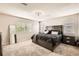 Bedroom with a large bed, plush carpeting, and windows bringing in natural light at 12125 Helena St, Brighton, CO 80603