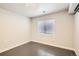 Neutral bedroom with gray concrete floors and light walls, and modern lighting fixture at 12125 Helena St, Brighton, CO 80603