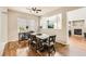 Dining area featuring hardwood floors, modern table set, and plenty of natural light at 12125 Helena St, Brighton, CO 80603