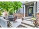 Inviting front porch with outdoor seating, stone accents, and a charming welcome sign at 12125 Helena St, Brighton, CO 80603