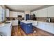 Well-lit kitchen featuring white cabinets, stainless steel appliances, and a kitchen island at 12125 Helena St, Brighton, CO 80603