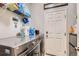 Clean laundry room featuring modern washer and dryer, lots of storage, and a door to the right at 12125 Helena St, Brighton, CO 80603