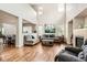 Spacious living room with soaring ceilings, hardwood floors, a fireplace, and an open floor plan at 12125 Helena St, Brighton, CO 80603