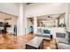 Open concept living area with hardwood floors, neutral decor, and seamless flow to other rooms at 12125 Helena St, Brighton, CO 80603