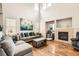 Bright living room with high ceilings, hardwood floors, a fireplace, and comfortable seating at 12125 Helena St, Brighton, CO 80603