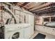 Basement laundry area with exposed brick and washer/dryer hookups at 710 E Alameda Ave, Denver, CO 80209