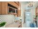 Updated kitchen featuring stainless steel appliances and stylish tile backsplash at 710 E Alameda Ave, Denver, CO 80209