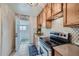 Charming kitchen with wooden cabinets, tile backsplash, and modern appliances at 710 E Alameda Ave, Denver, CO 80209