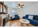 Cozy living room featuring hardwood floors, fireplace, and comfortable blue seating at 710 E Alameda Ave, Denver, CO 80209