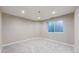 Finished basement featuring neutral paint, recessed lighting, gray carpet and large window at 9255 Melborne Ct, Parker, CO 80134