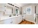 The bathroom has dual vanities with white countertops and wood-look floors at 9255 Melborne Ct, Parker, CO 80134