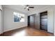 Bright bedroom with a large window and a built in murphy bed with shelving at 9255 Melborne Ct, Parker, CO 80134