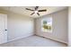Bedroom features neutral walls, carpet, ceiling fan, and bright window at 9255 Melborne Ct, Parker, CO 80134