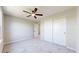 A bedroom features sliding door closet, neutral walls, plush carpet, and ceiling fan at 9255 Melborne Ct, Parker, CO 80134