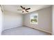 A bright bedroom features neutral walls and carpet, along with a ceiling fan at 9255 Melborne Ct, Parker, CO 80134