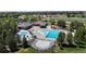 Aerial view of a community pool with ample seating, sunshades and lounge chairs on the pool deck at 9255 Melborne Ct, Parker, CO 80134