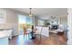 Bright dining area with hardwood floors, views, and adjacent to a living room with a fireplace at 9255 Melborne Ct, Parker, CO 80134
