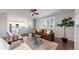 Open-concept living room with hardwood floors, flows into a modern white kitchen, perfect for entertaining at 9255 Melborne Ct, Parker, CO 80134