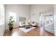 Bright living room featuring soaring ceilings, hardwood floors, and an abundance of natural light at 9255 Melborne Ct, Parker, CO 80134