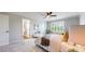 Bright main bedroom features a ceiling fan, window with shutters, and an ensuite bathroom at 9255 Melborne Ct, Parker, CO 80134