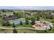 Aerial view of a neighborhood park with tennis courts, basketball court, playground and green space at 9255 Melborne Ct, Parker, CO 80134