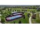 Aerial view of neighborhood tennis and basketball courts nestled in a green park space at 9255 Melborne Ct, Parker, CO 80134