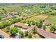 This aerial view shows a large property with a home, sheds, and fenced boundary at 9880 E 157Th Ave, Brighton, CO 80602