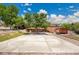 This spacious backyard features a concrete patio, a spacious deck with stairs, and a charming pergola-covered seating area at 9880 E 157Th Ave, Brighton, CO 80602