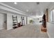 Finished basement with neutral carpeting, ample lighting, and bonus entertainment space at 9880 E 157Th Ave, Brighton, CO 80602