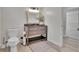 Bathroom featuring dark vanity and natural light, situated next to the toilet at 9880 E 157Th Ave, Brighton, CO 80602