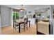 Inviting dining room with stylish table set and hardwood floors, flowing into the kitchen at 9880 E 157Th Ave, Brighton, CO 80602