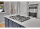 Modern kitchen island featuring a cooktop and sleek countertops at 9880 E 157Th Ave, Brighton, CO 80602