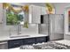 Kitchen features a stainless steel refrigerator and undermount sink with a window view at 9880 E 157Th Ave, Brighton, CO 80602