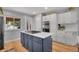 Bright kitchen with island cooktop, hardwood floors, and stainless steel appliances at 9880 E 157Th Ave, Brighton, CO 80602