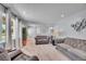 Bright, open living area with comfortable seating, neutral decor, and ample natural light at 9880 E 157Th Ave, Brighton, CO 80602